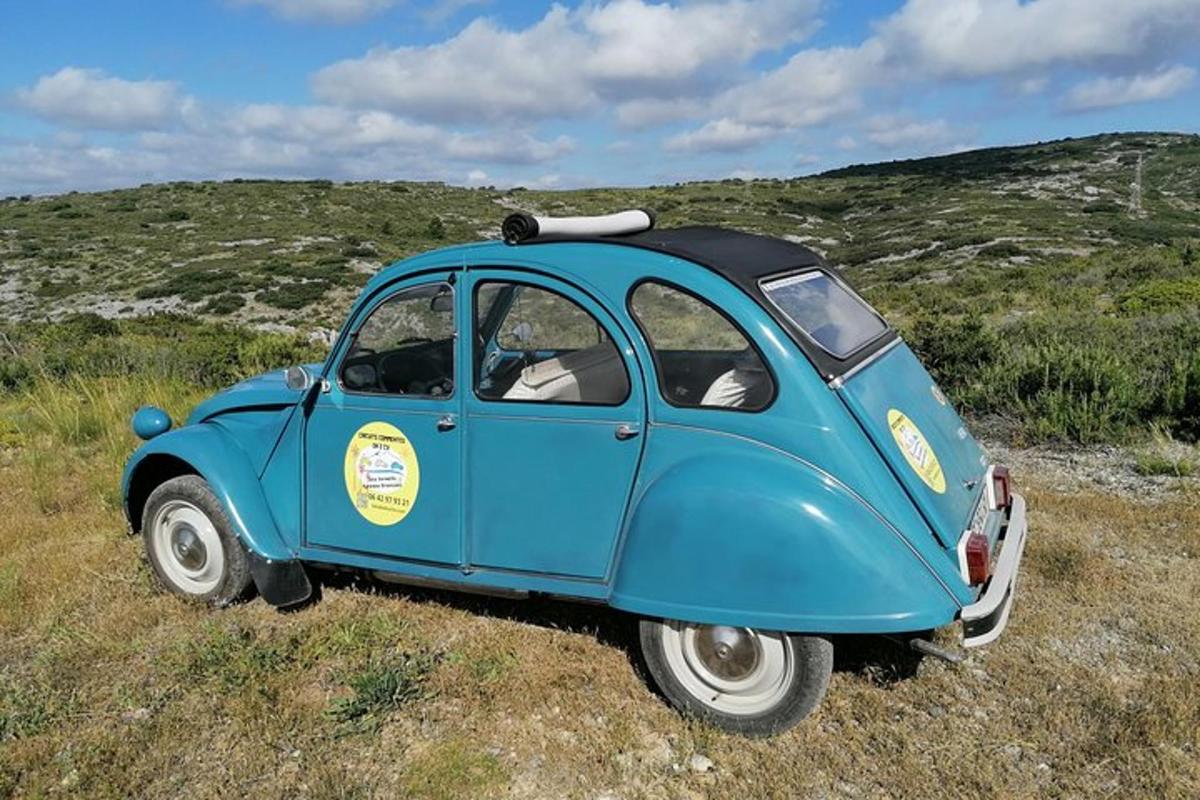 a small blue car parked in a field