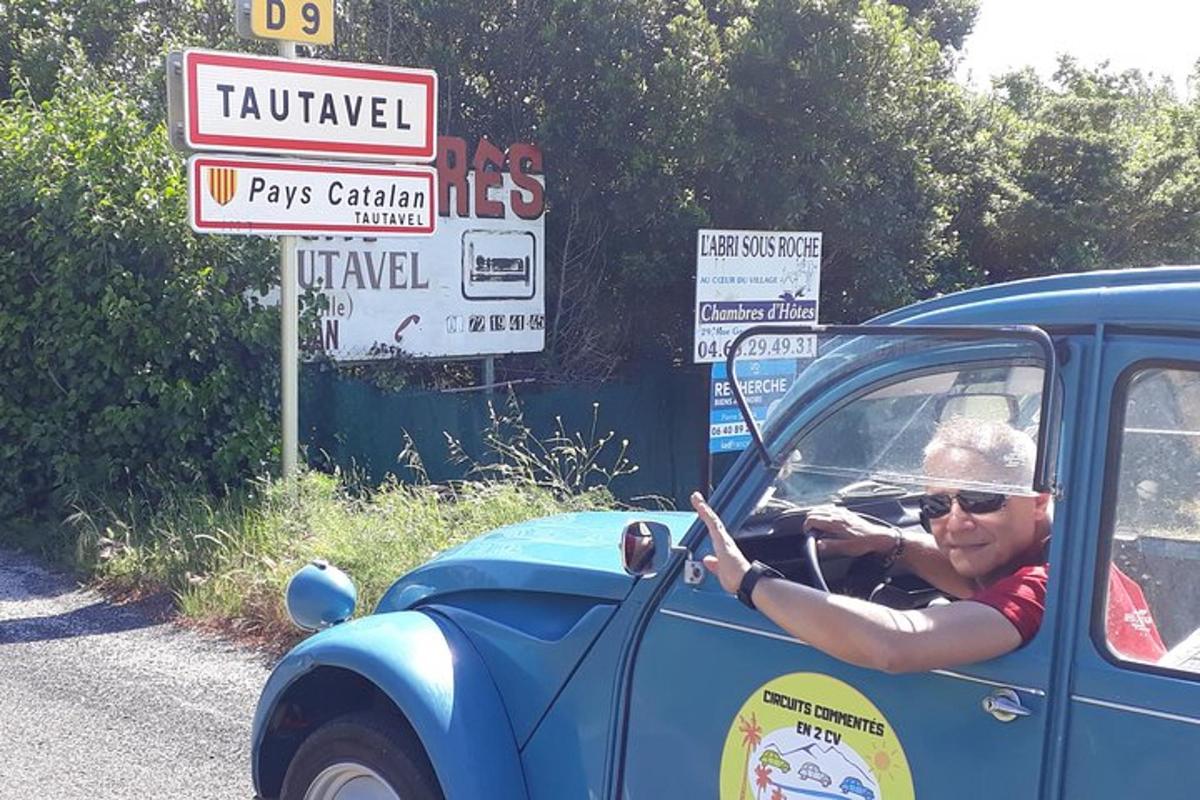 a man is sitting in a blue car