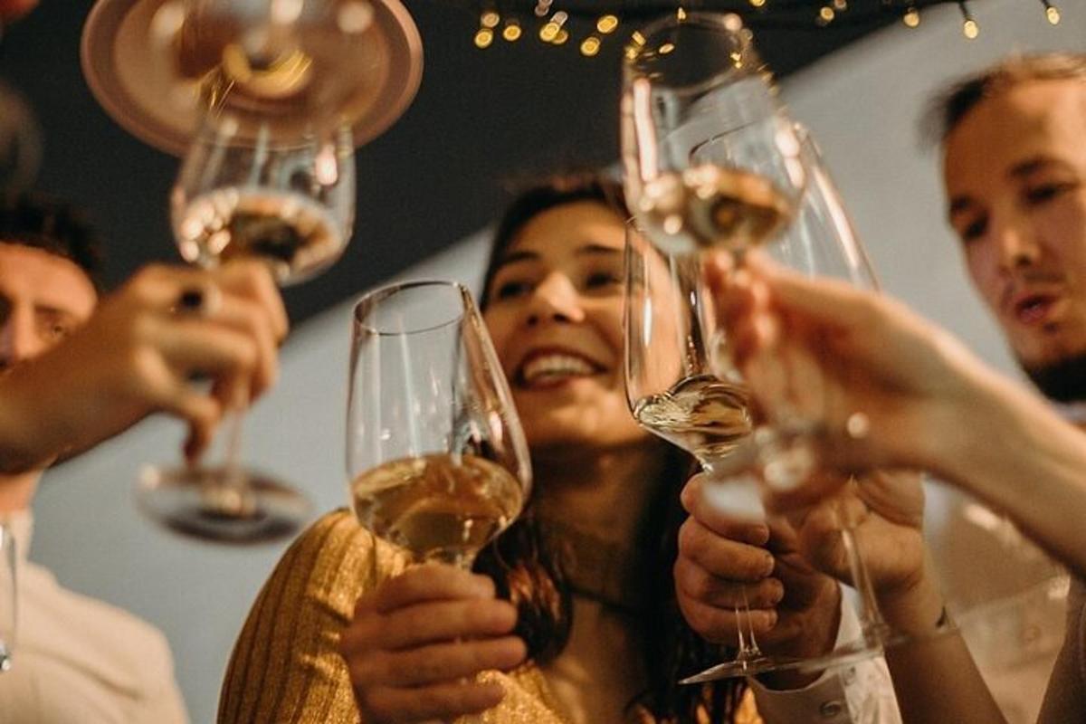 skupina ljudi, ki držijo kozarce za vino
