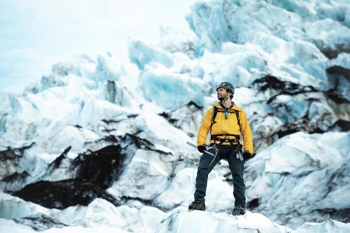 a man standing on top of a glacier