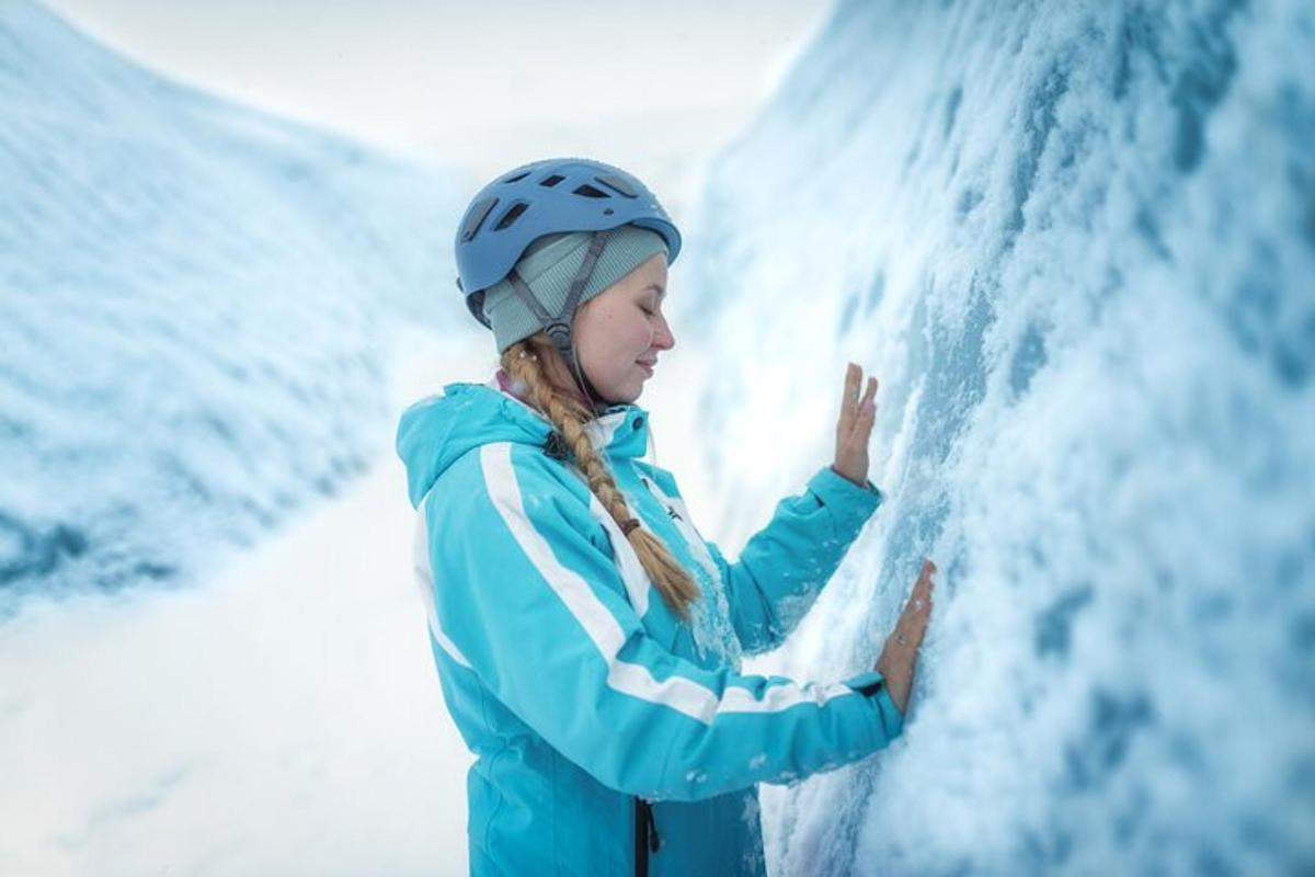 a young girl in a helmet is standing in front of a waterfall