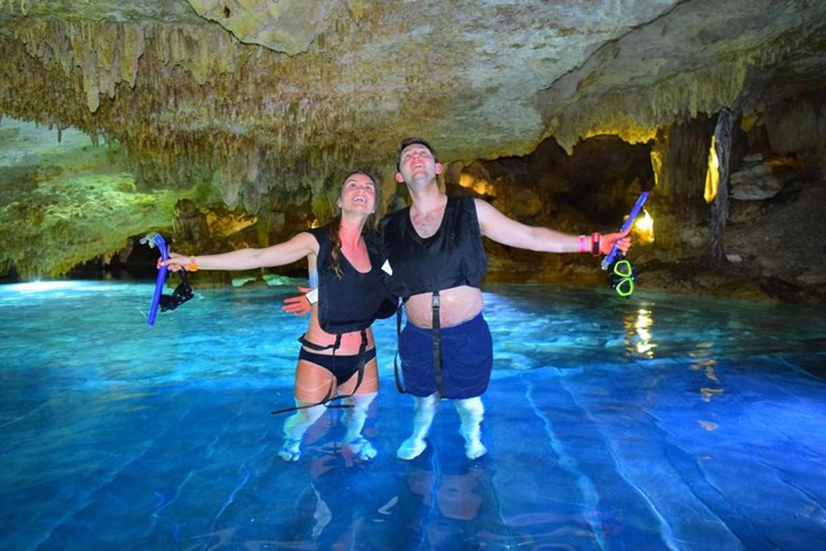 un uomo e una donna in piedi nell'acqua in una grotta