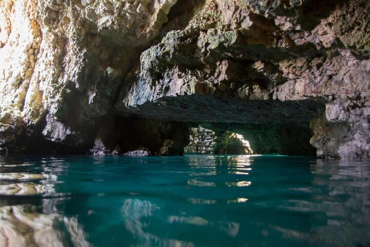 a cave with blue water in front of it