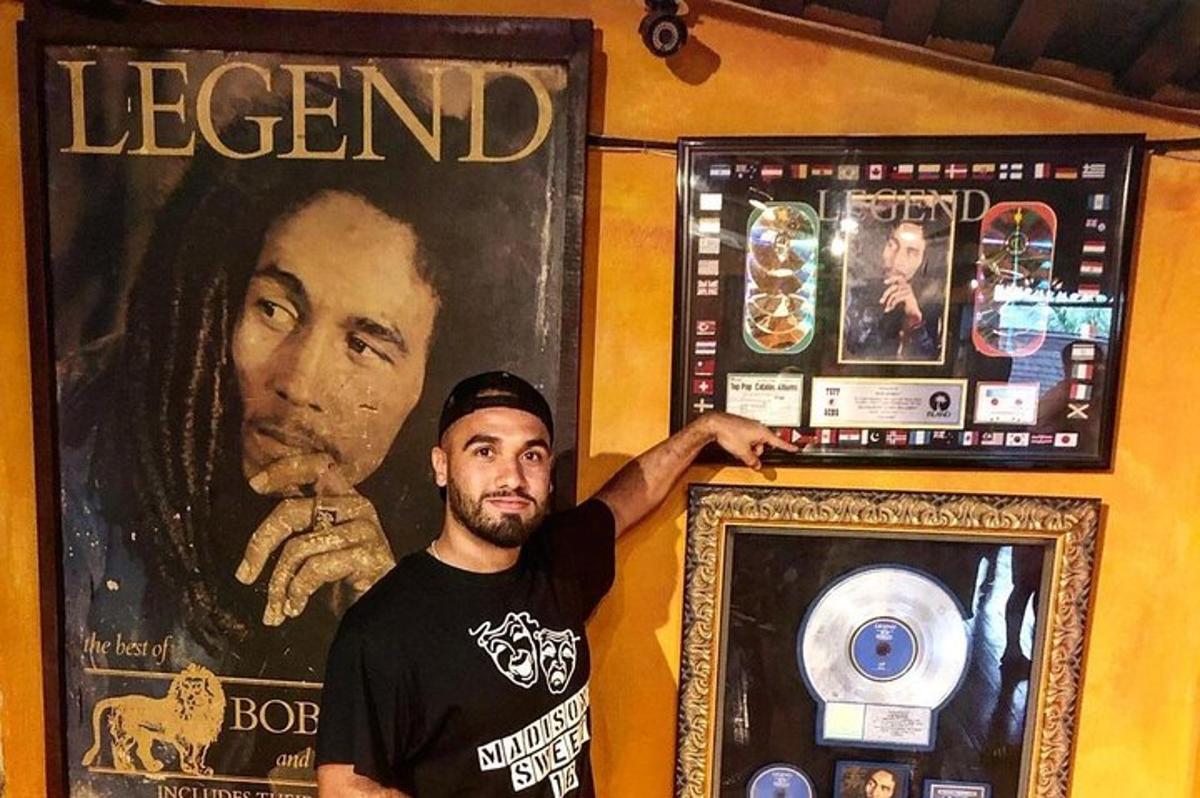 ein Mann steht neben einem Legendenschild und einem Bild
