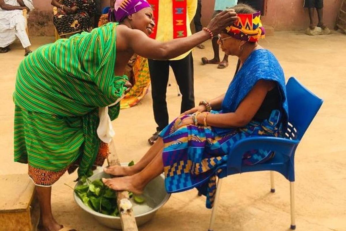 a woman is helping a woman get her hair cut