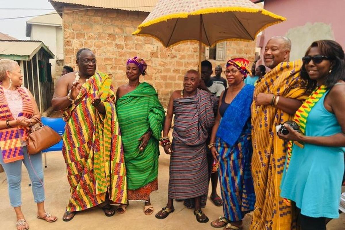 a group of people posing for a picture under an umbrella