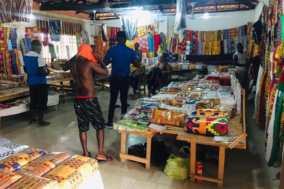 a group of people standing in a market with merchandise