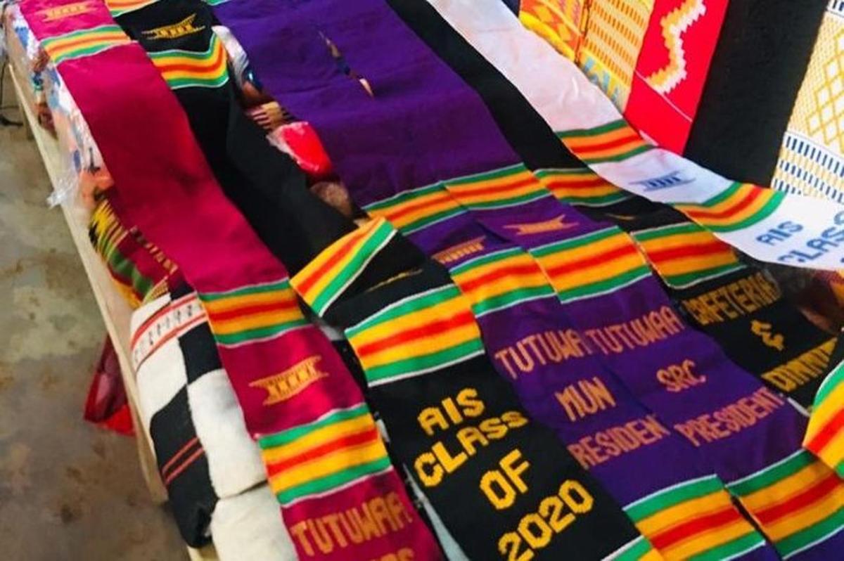 a close up of a bed with a colorful blanket