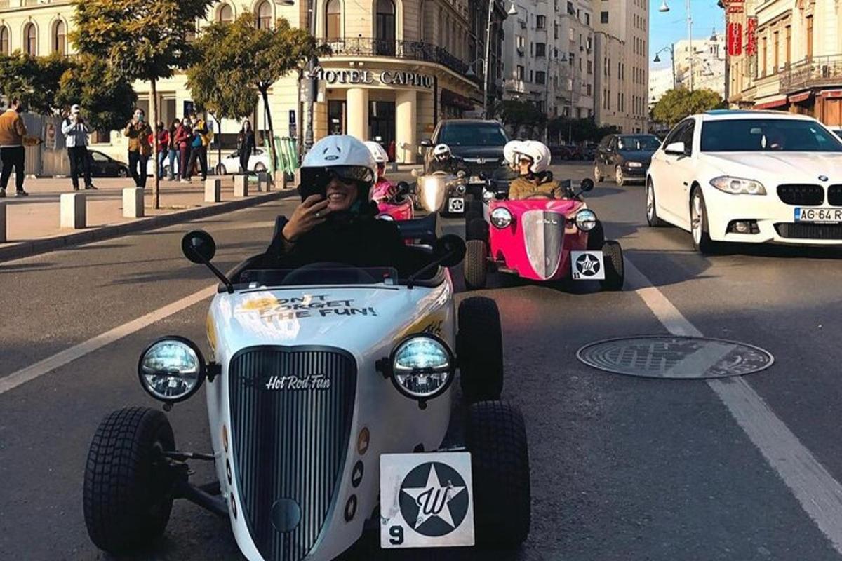 a man riding in a car on a city street