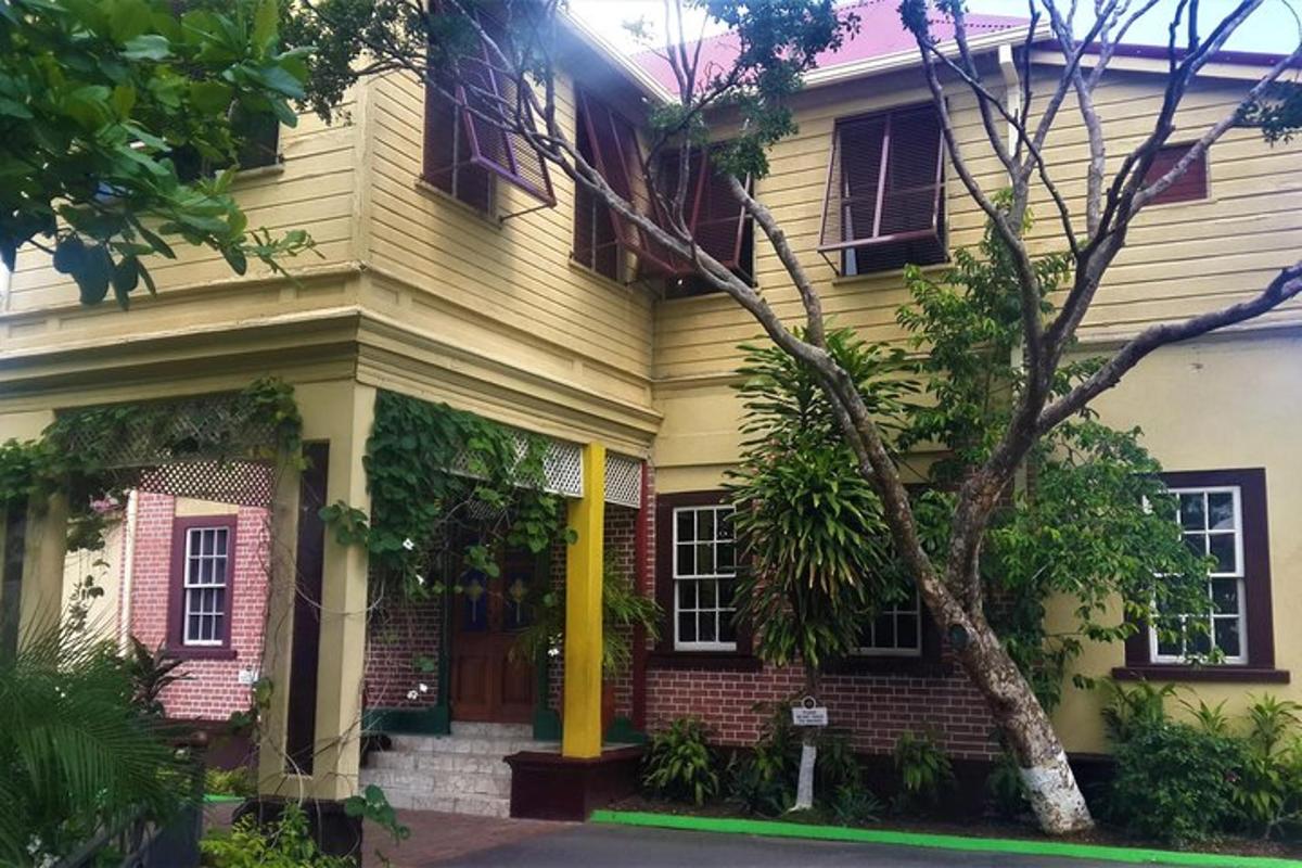 a yellow house with a tree in front of it