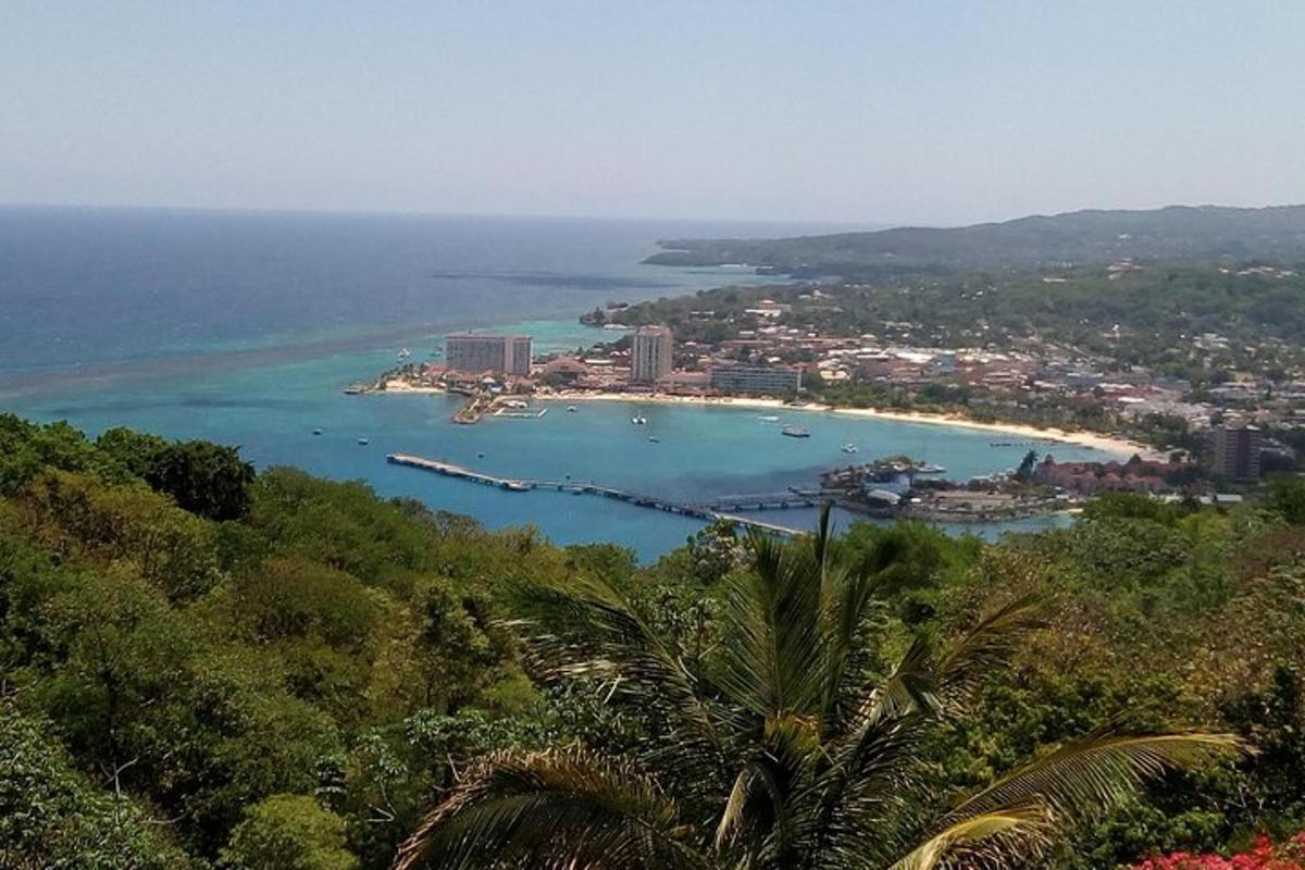 a view of a beach with a city and the ocean