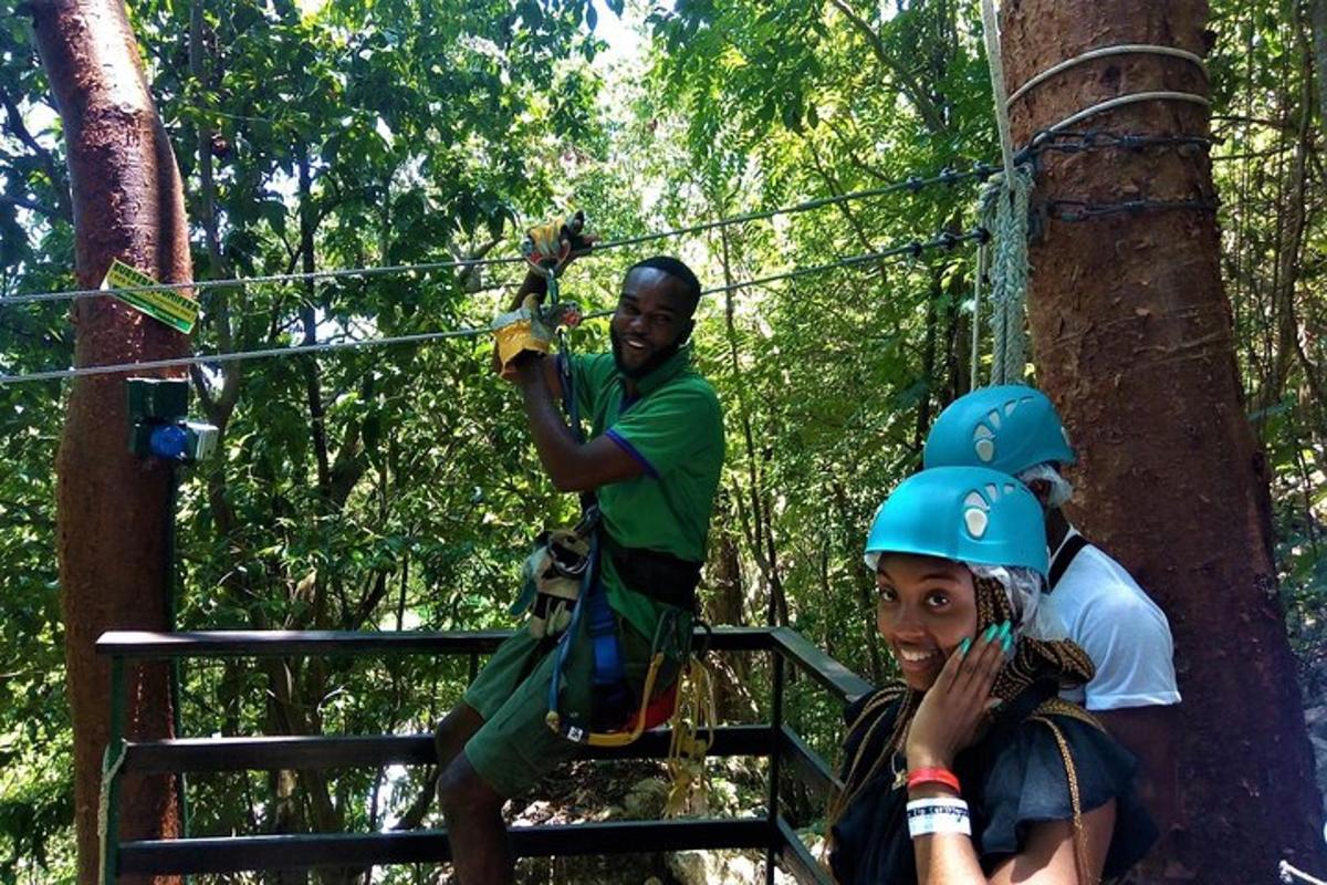 a group of people on a zip line in the trees