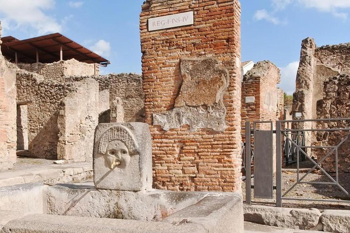 a statue of a head in front of a brick building