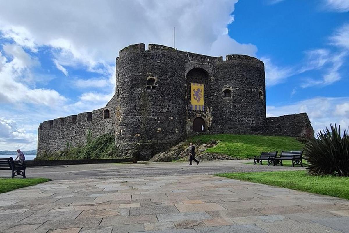 a castle sitting on top of a hill next to the ocean