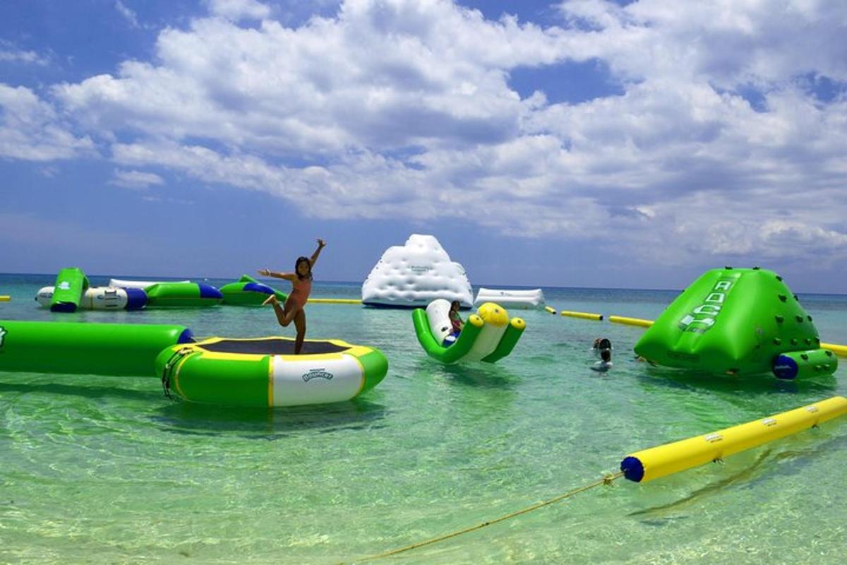 a group of inflatables in the water at a beach