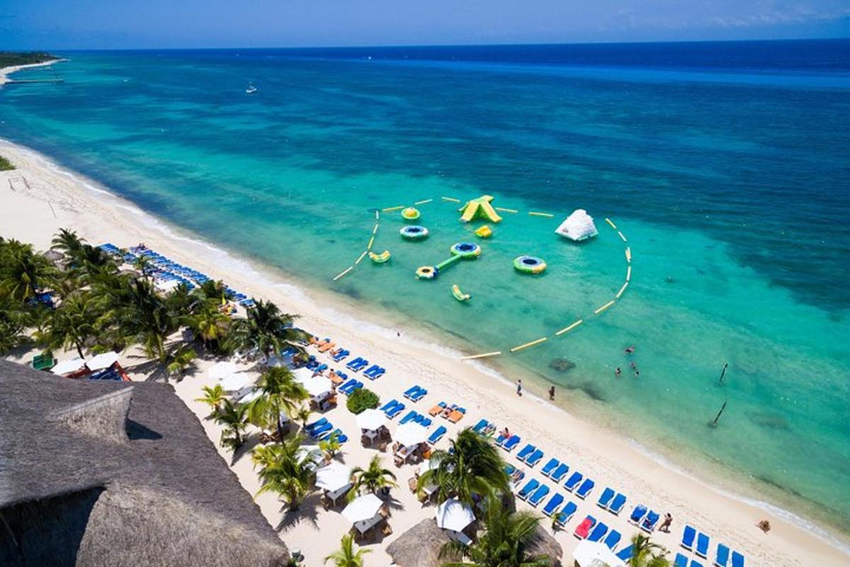 an aerial view of a beach with people and the ocean