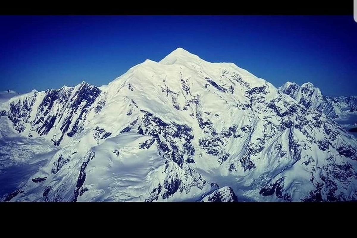 a large mountain covered in snow on a clear day