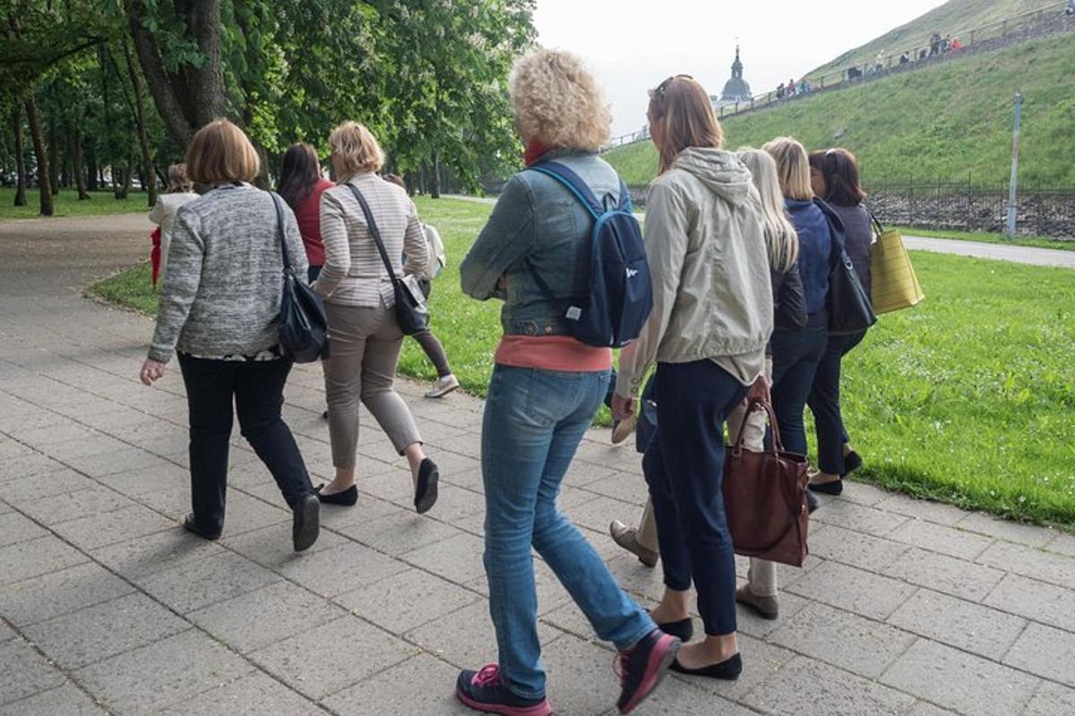 a group of people walking down a sidewalk