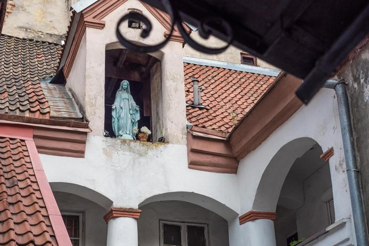 a building with a statue of a woman in a window