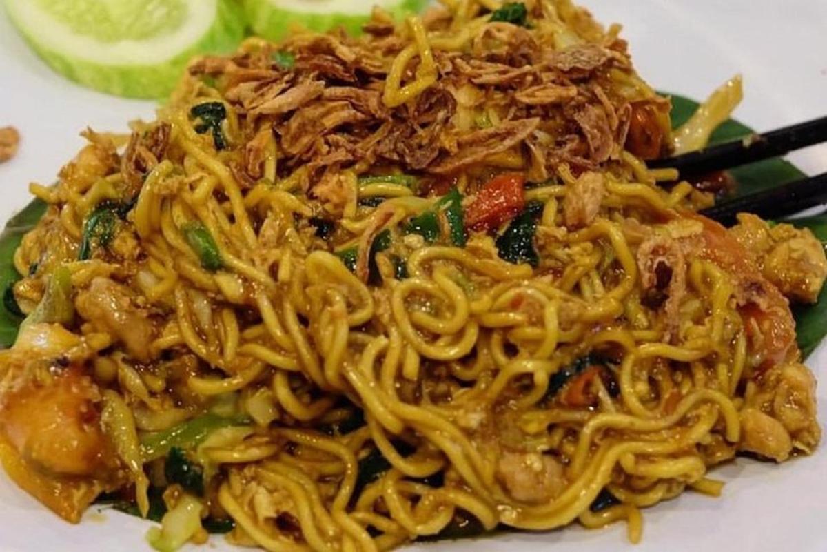 ein Teller mit Essen mit Nudeln auf einem Teller mit Stäbchen