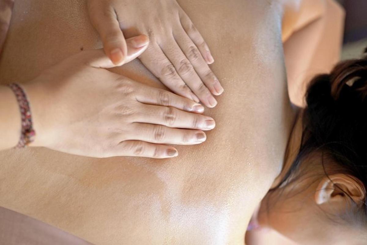 a woman with her hands on her back