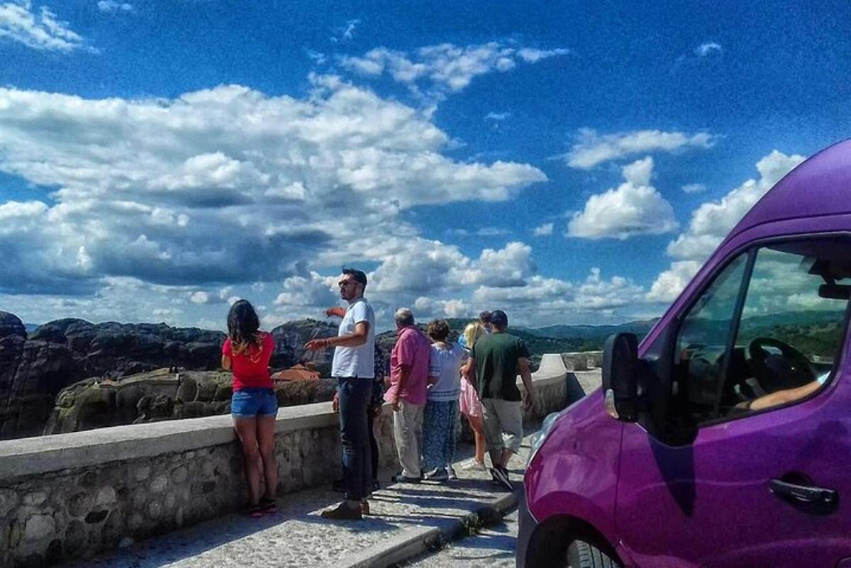 a group of people standing on the edge of a wall