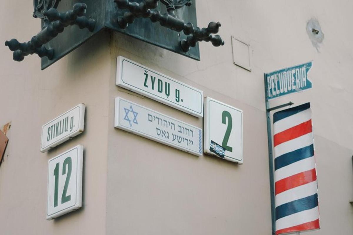 a group of street signs on the side of a building
