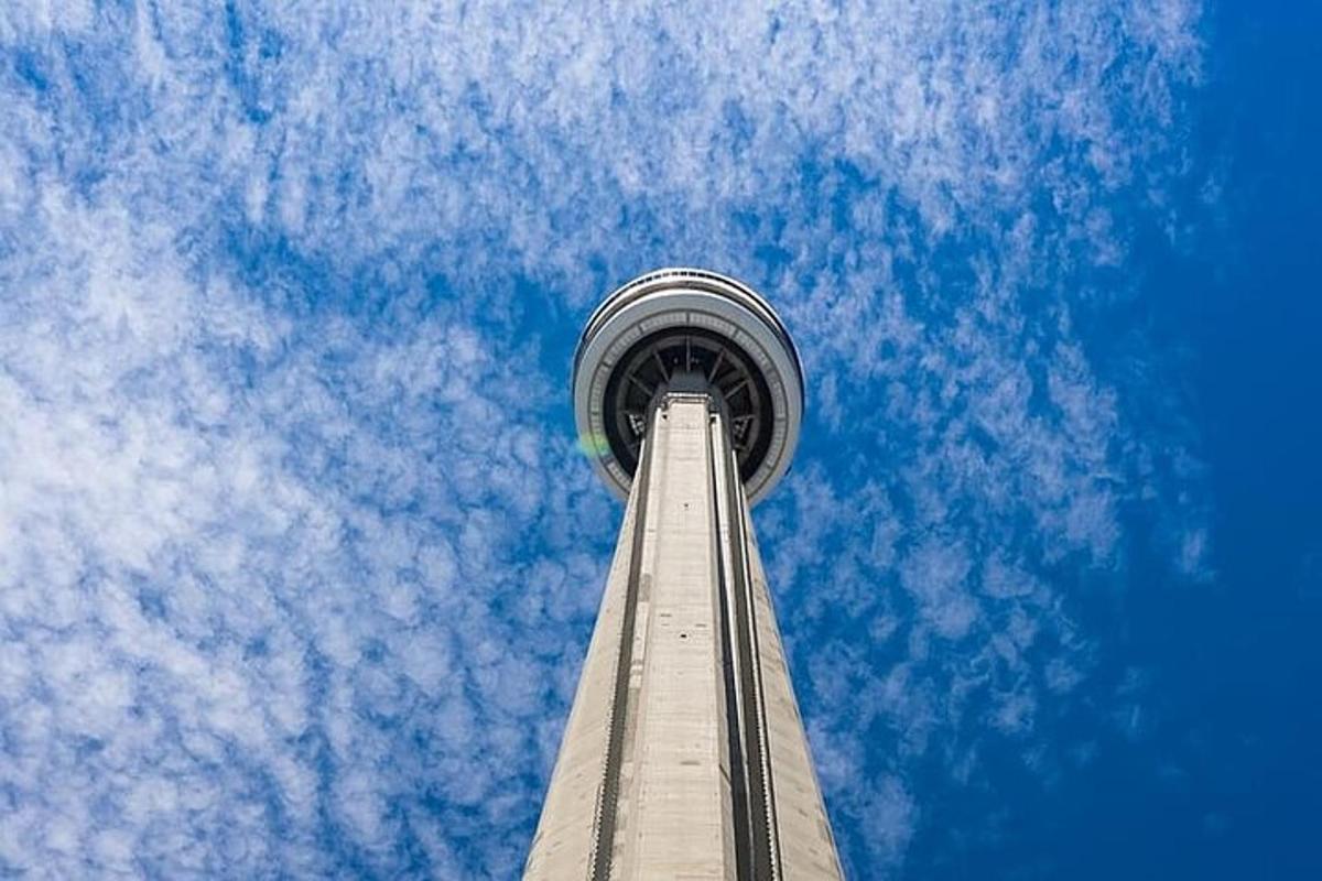 a tall tower with a blue sky and clouds