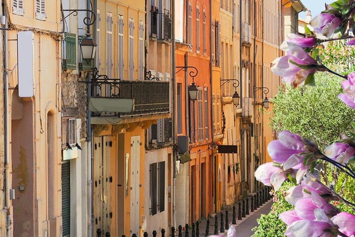 建物と紫色の花が咲く街路