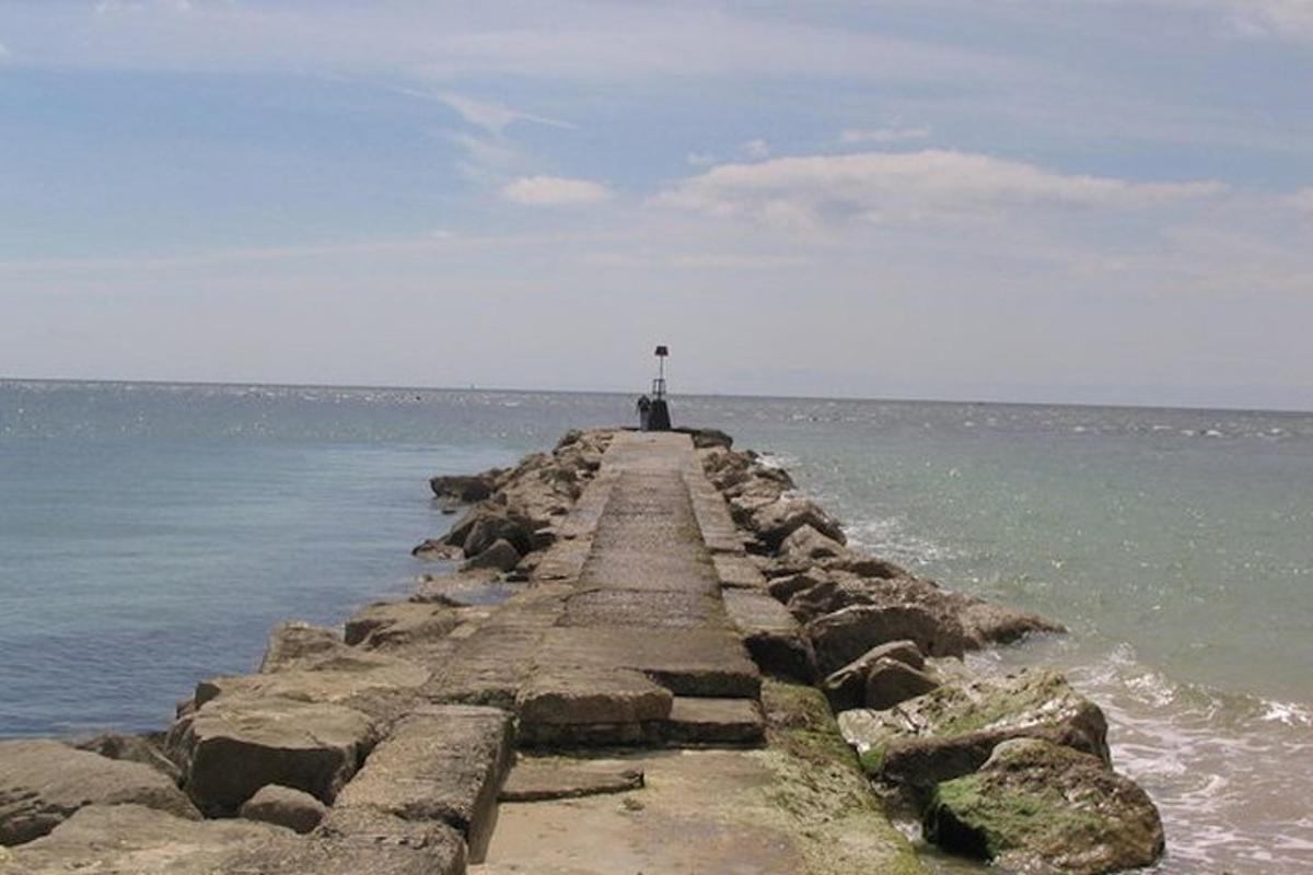 a pier in the ocean with a lighthouse on it