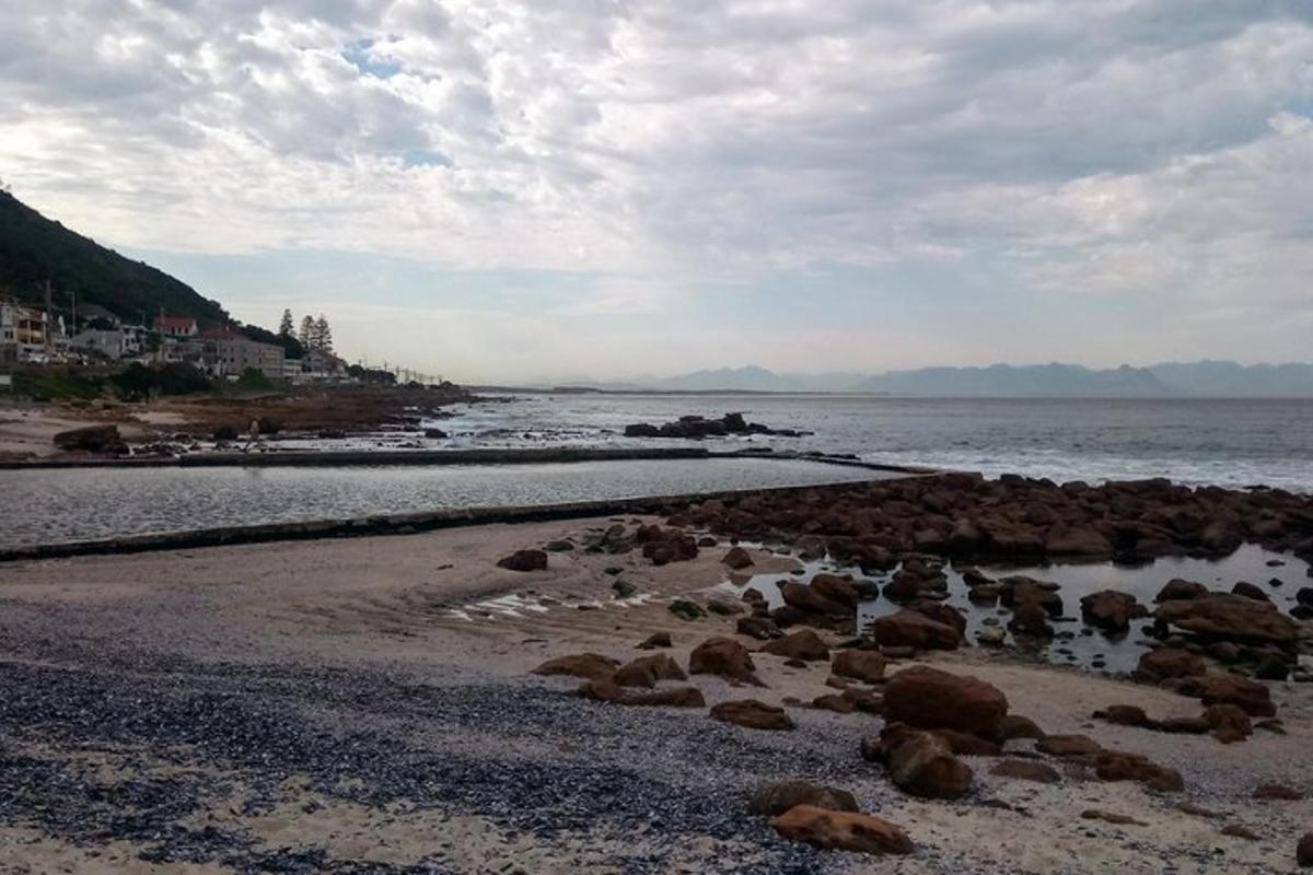 o plajă cu stânci și ocean cu un cer înnorat