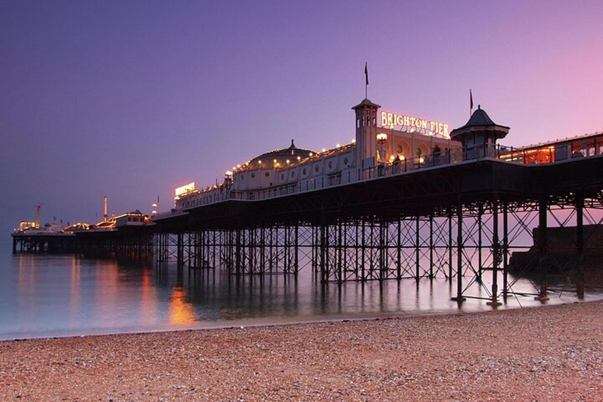 a pier with a building on the water at night