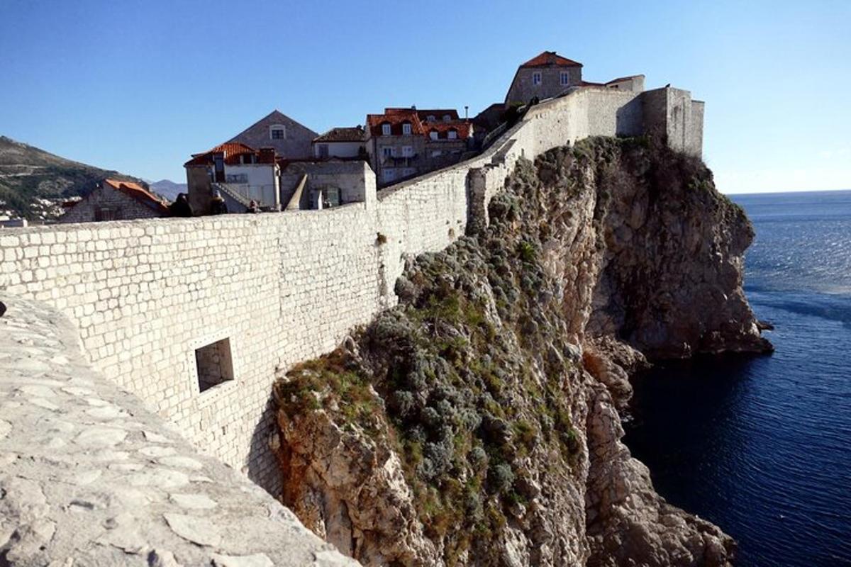 a castle on a cliff next to the water