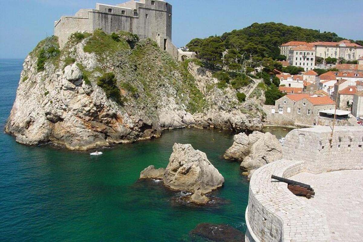 a castle sitting on top of a rocky island in the water