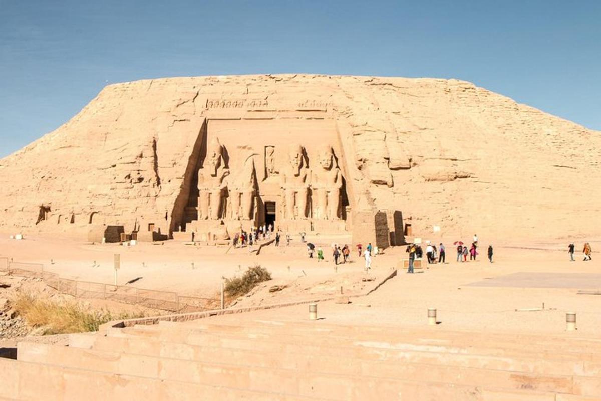 skupina lidí stojící před pyramidou