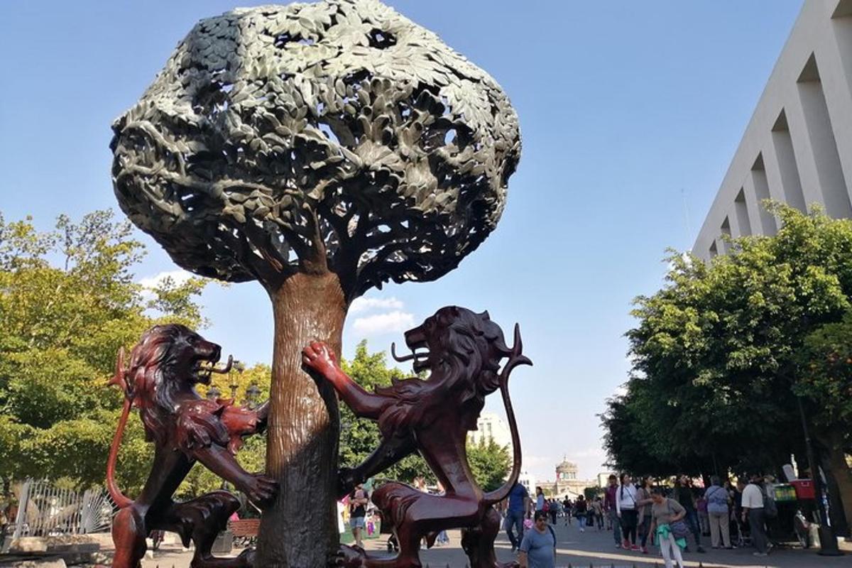 a statue of three children playing in a tree