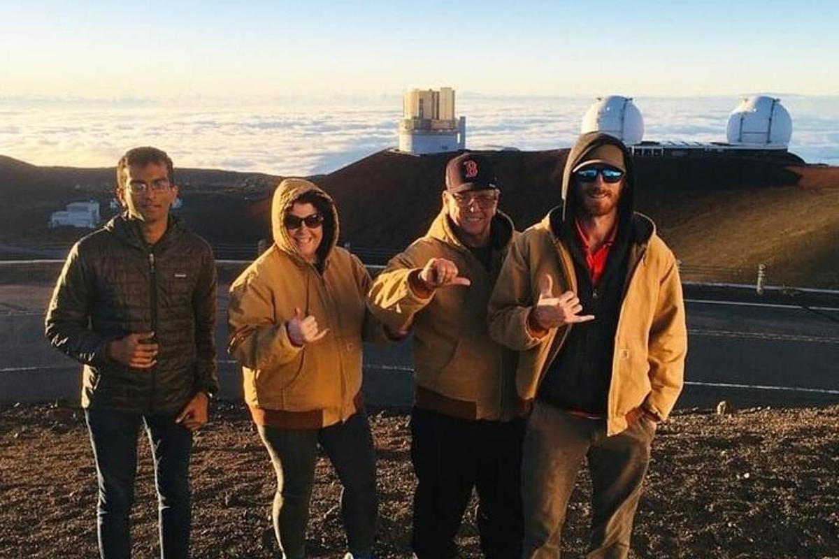 a group of people standing on top of a mountain
