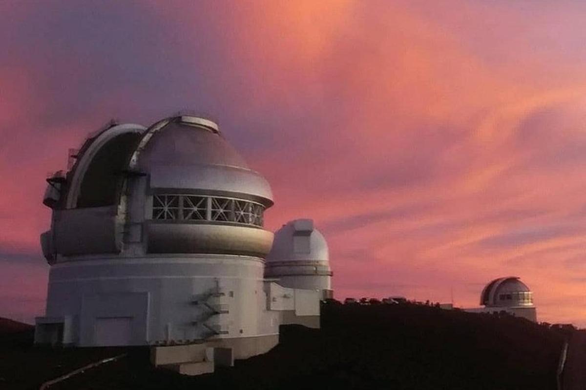 a building with two observatories and a cloudy sky