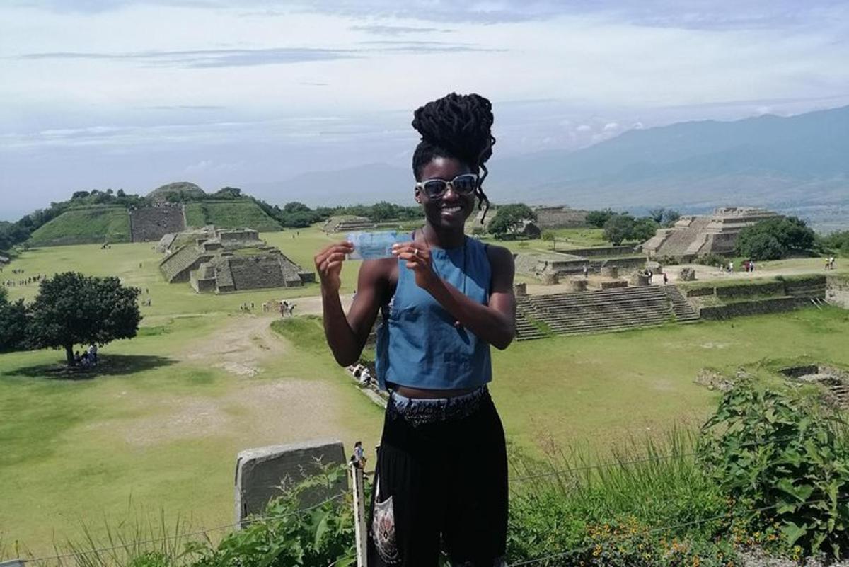 a woman standing at the ruins of a pyramid