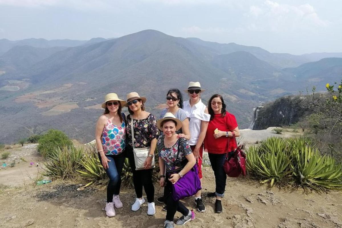 a group of people standing on top of a mountain
