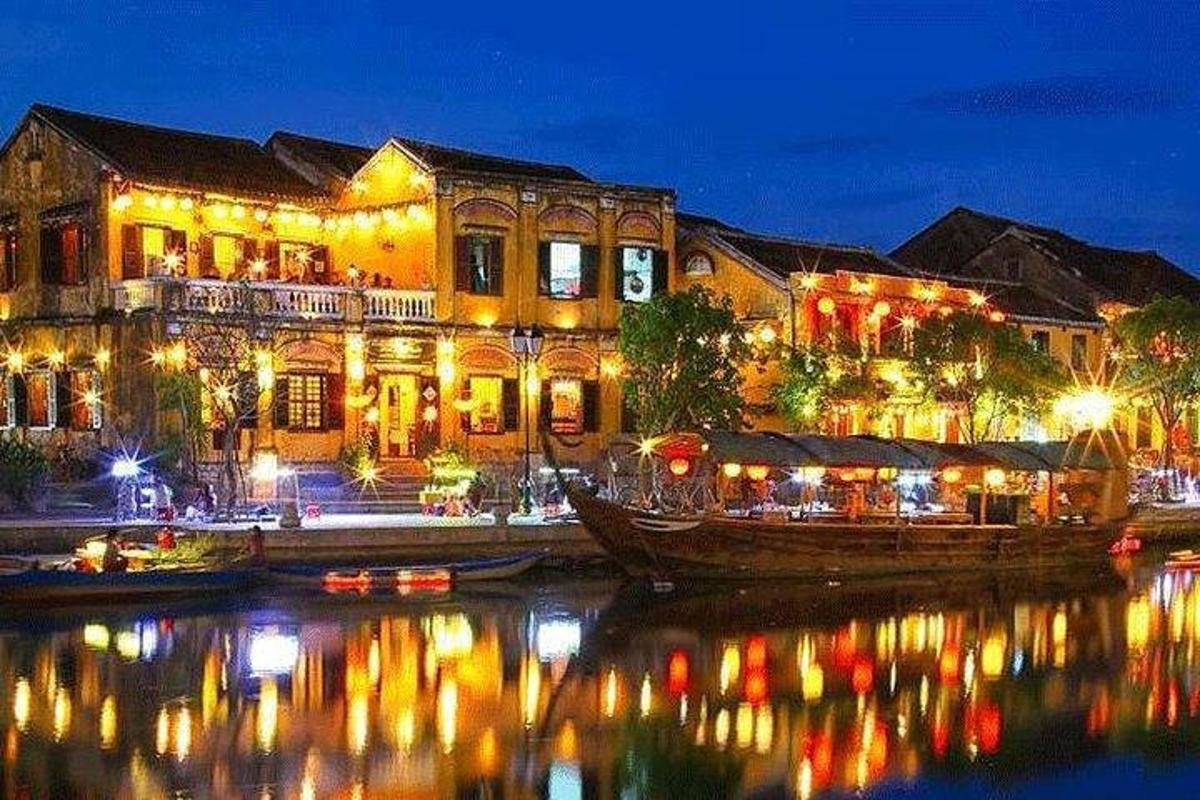 a building with lights on the water at night