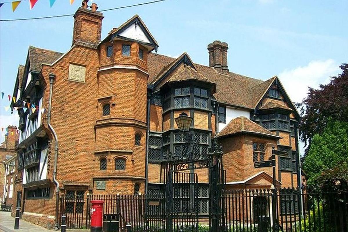 an old brick building with a fence in front of it