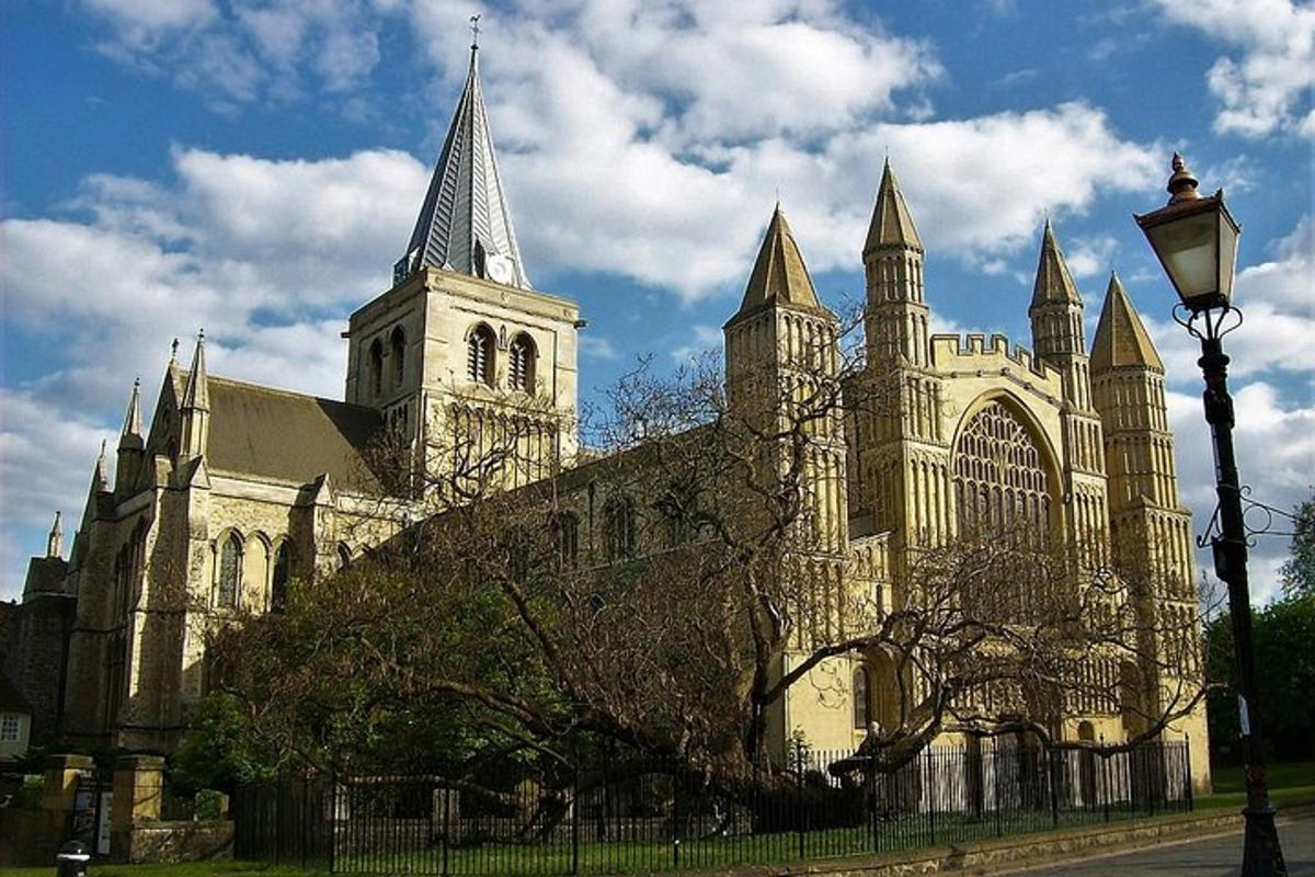 a large cathedral with a clock tower and a street light