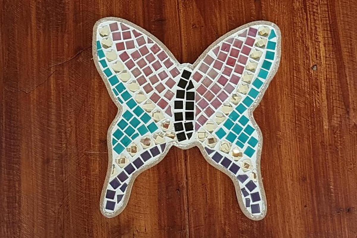 a butterfly shaped object on a wooden floor
