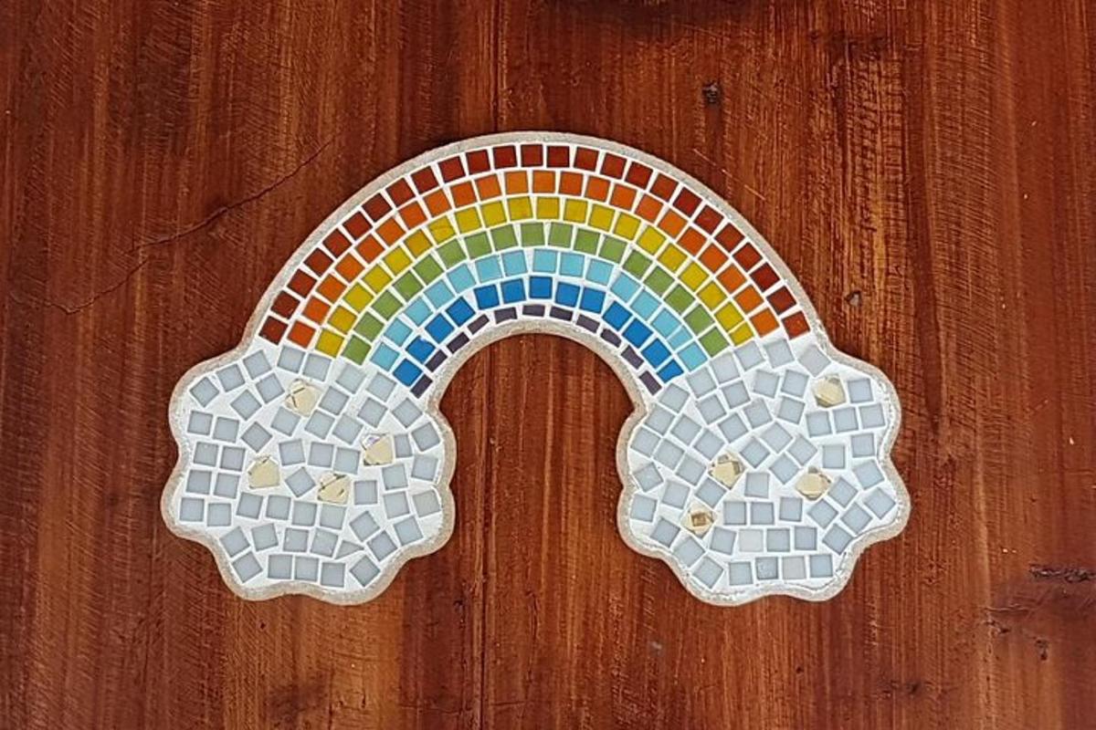 two mosaics of a rainbow on a wooden wall