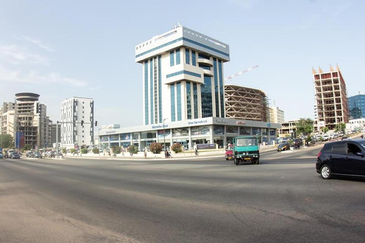 a large building in a city with cars on a street