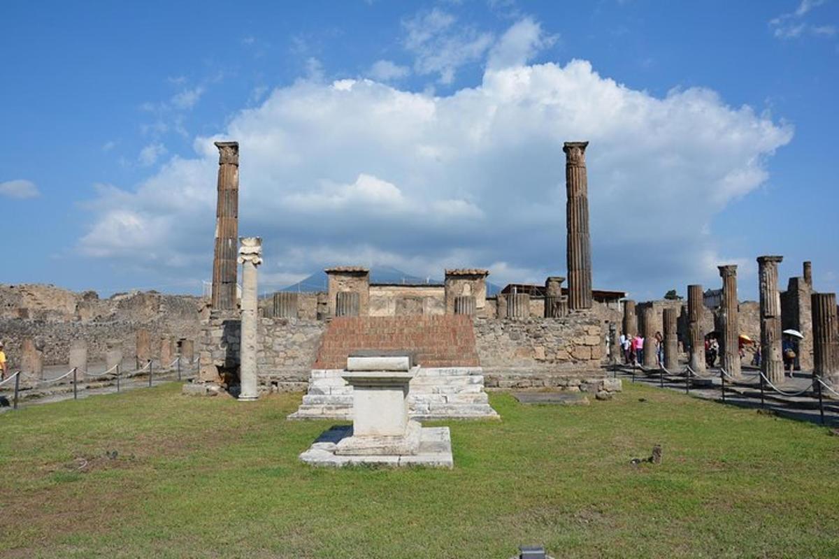 an ancient building with columns in a field
