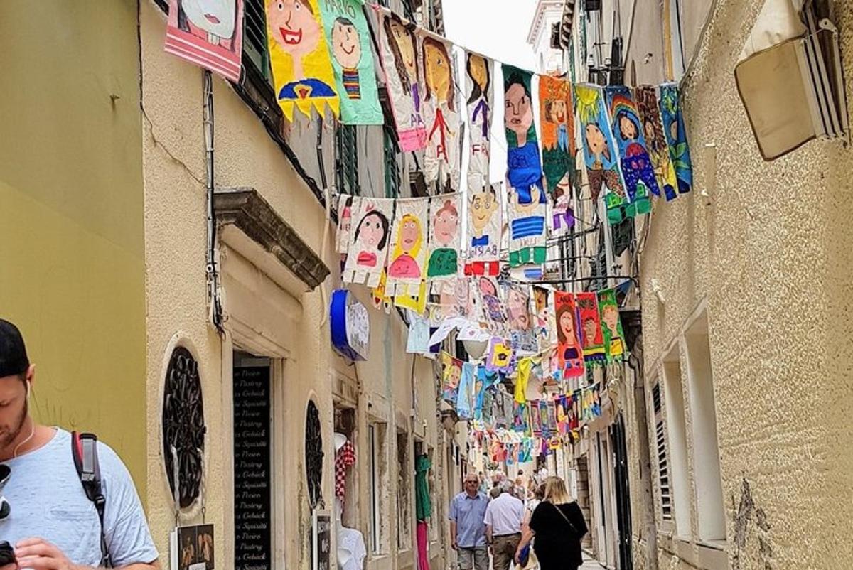 a group of people walking down a street with flags and clothes pins