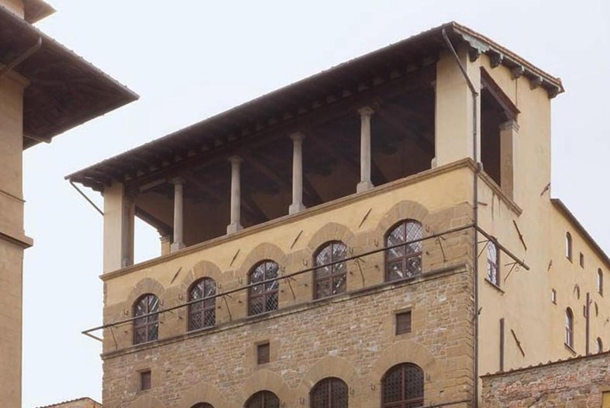 Un edificio con un balcón en la parte superior.