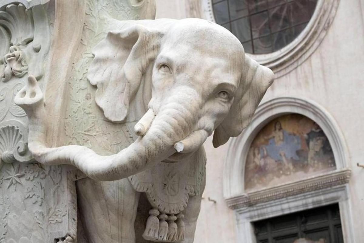 a statue of an elephant on the side of a building